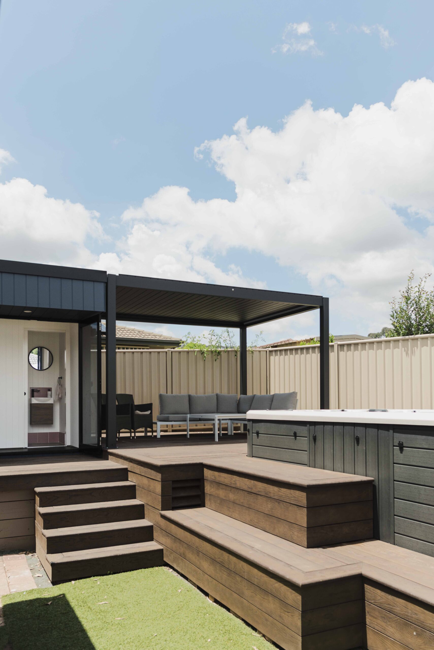 covered verandah adjoining backyard office with spa in foreground